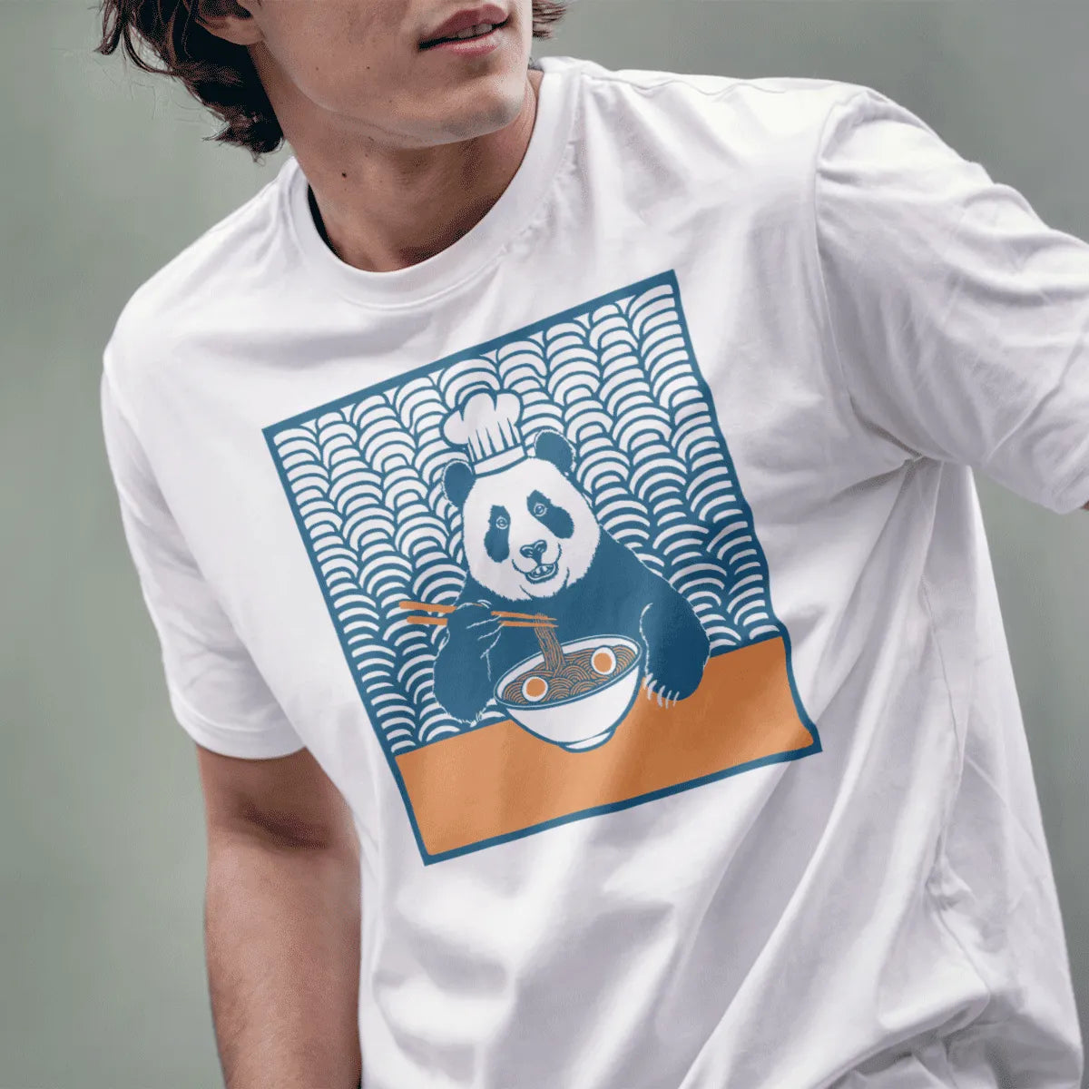 Male model in white t-shirt with chef panda ramen art, japanese t-shirts and umami noodles, lower face visible.