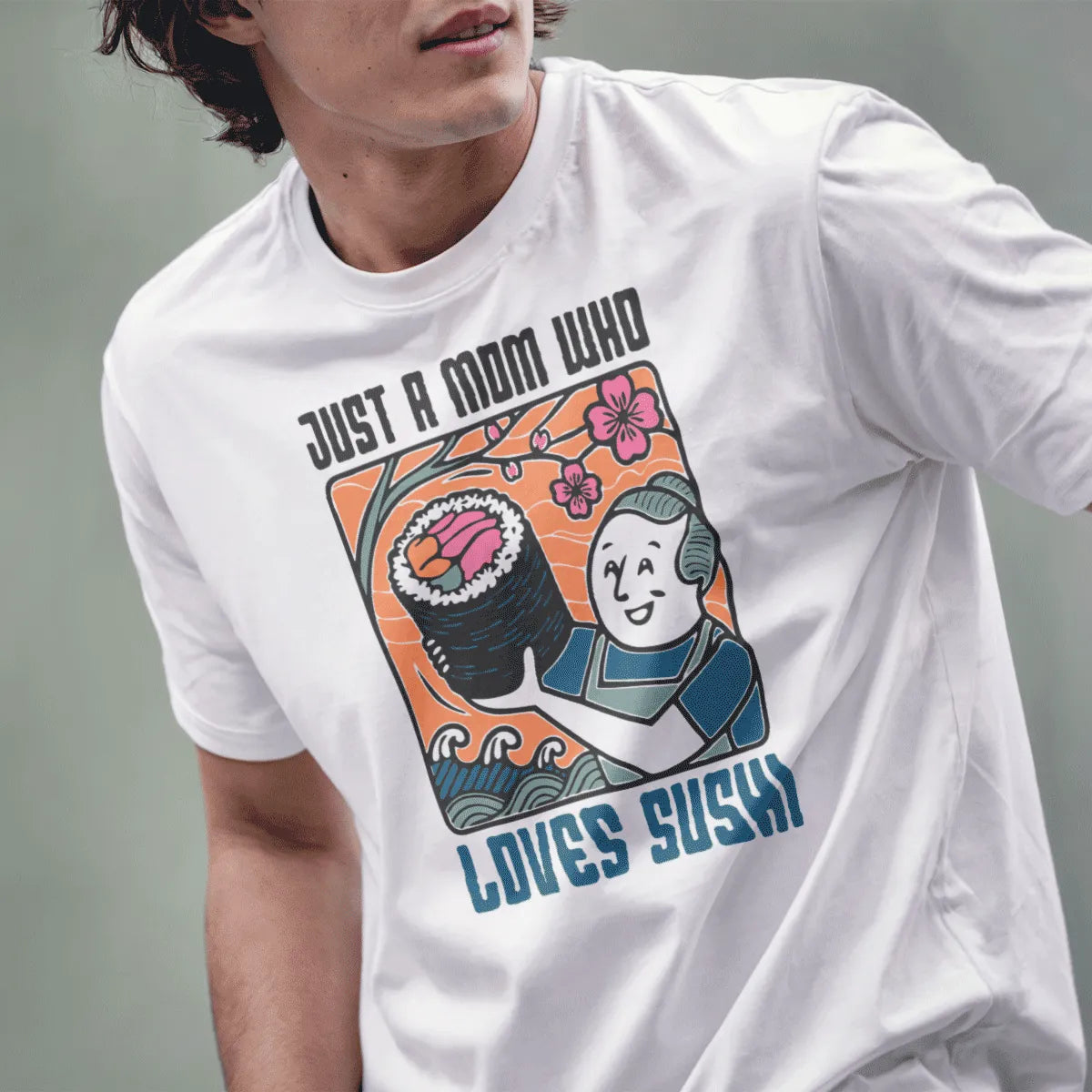 Male model in white t-shirt with sushi mom design, cherry blossoms, and friendly bold text.