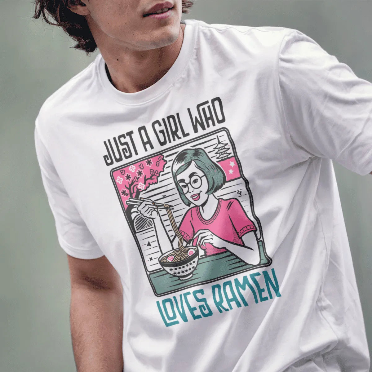 Male model in white t-shirt with smiling girl, ramen bowl, and soft colors; ramen t-shirt, positive messaging.