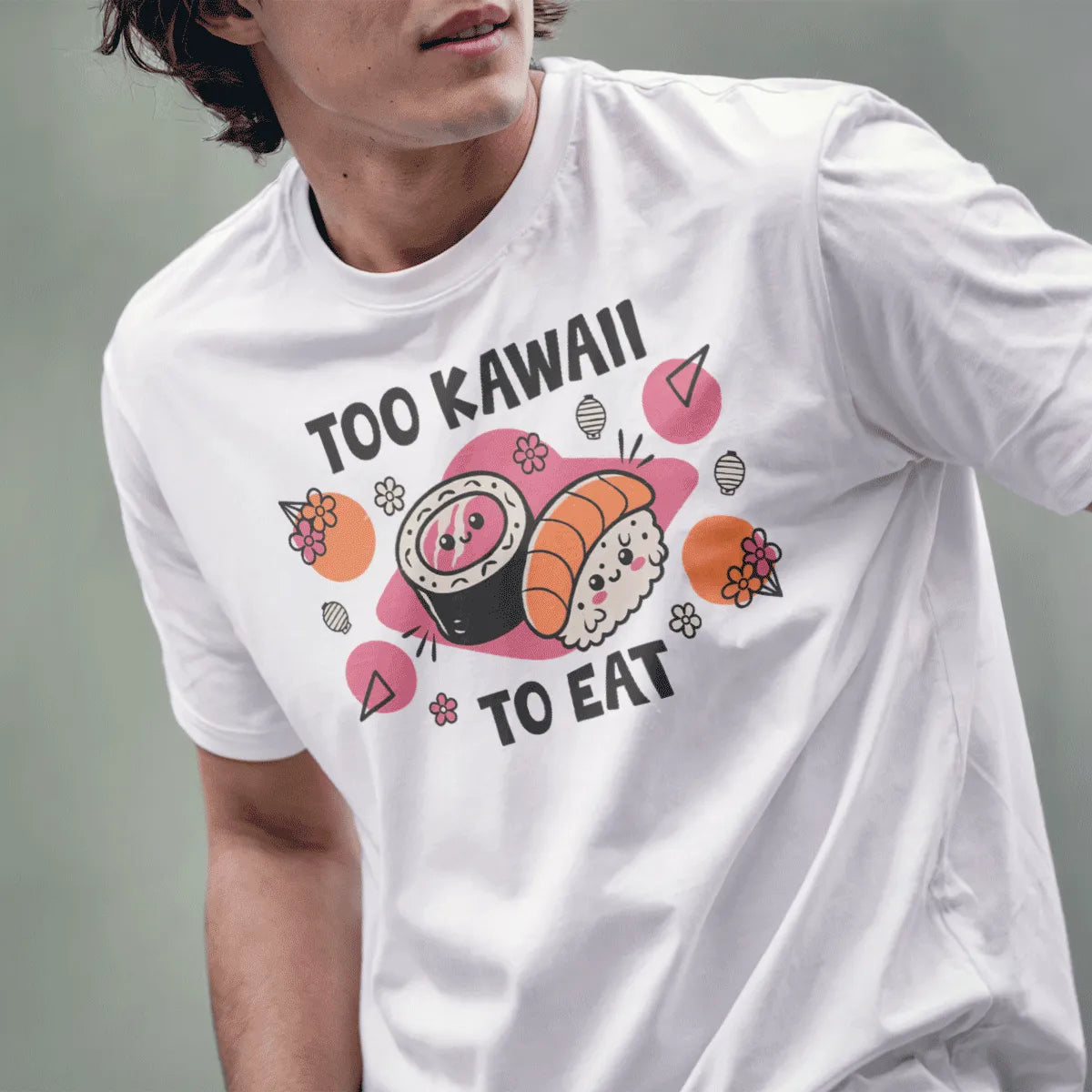 Male model wearing white t-shirt with kawaii sushi faces, too kawaii to eat text, and floral accents.