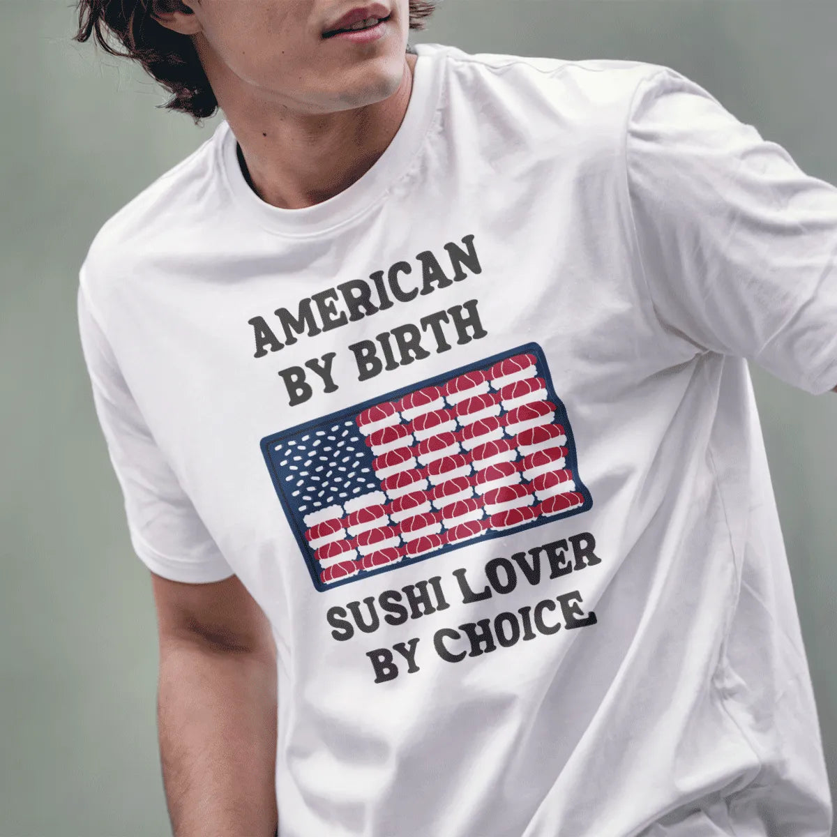 Male model wears white t-shirt with sushi flag design, sushi lover phrase, and playful patriotic theme.