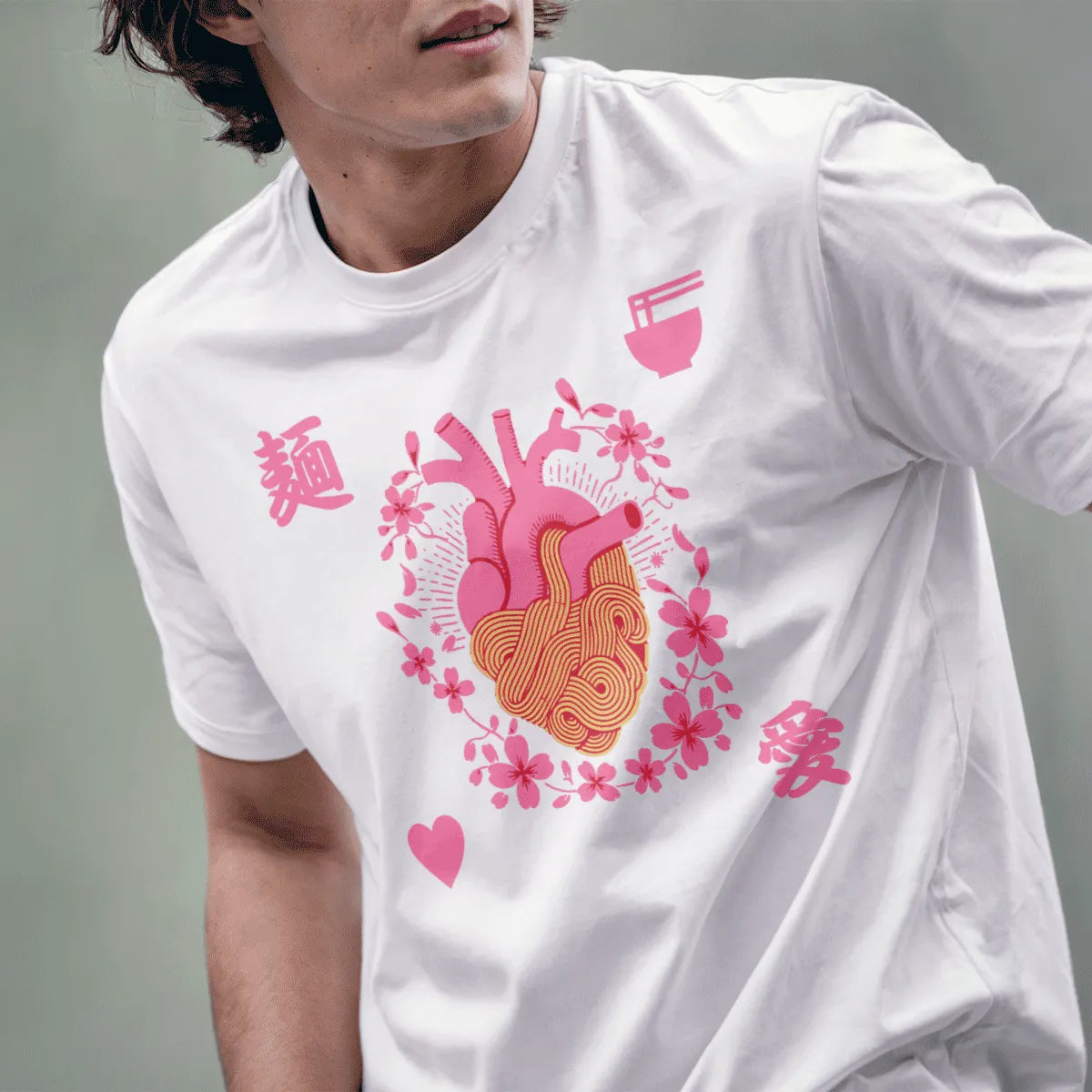 Male model in white t-shirt with heart and noodles design, cherry blossom accents, ramen t-shirt.