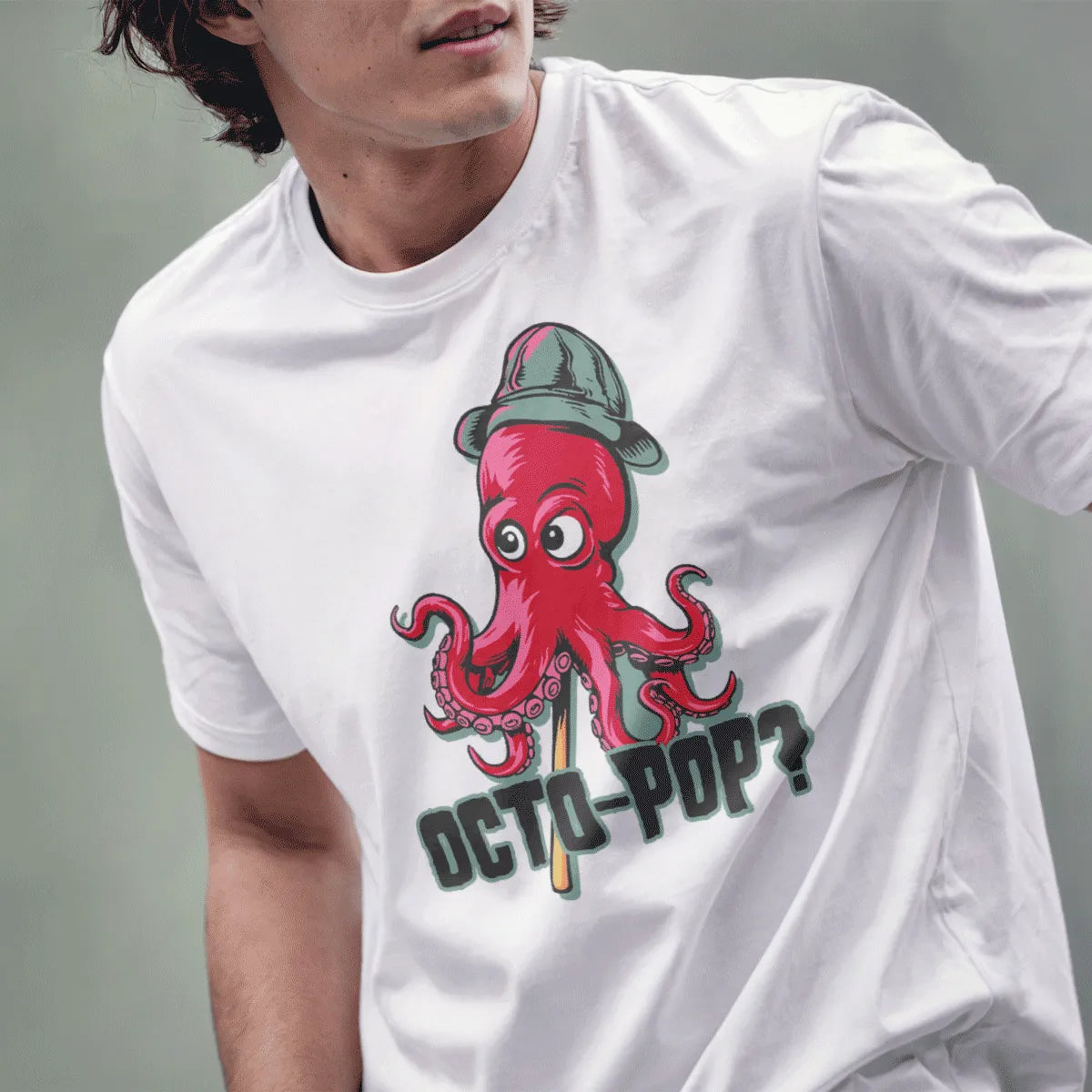Male model in white t-shirt with red octopus, gray hat, and "OCTO-POP?" text, octopus art.