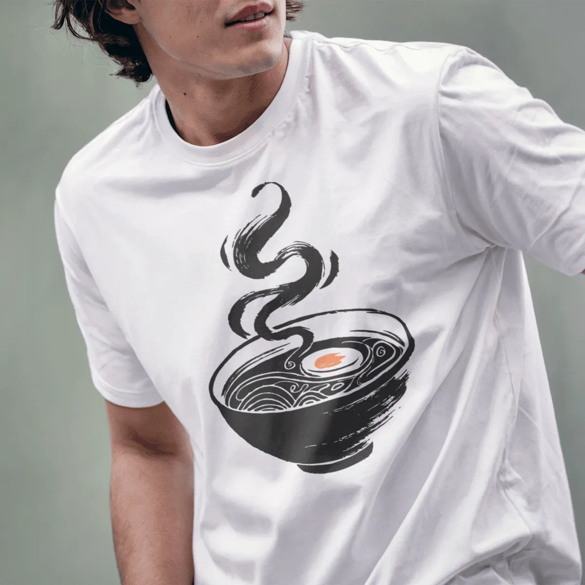 Male model in white ramen t-shirt, minimalist bowl design with orange accent, lower face visible.