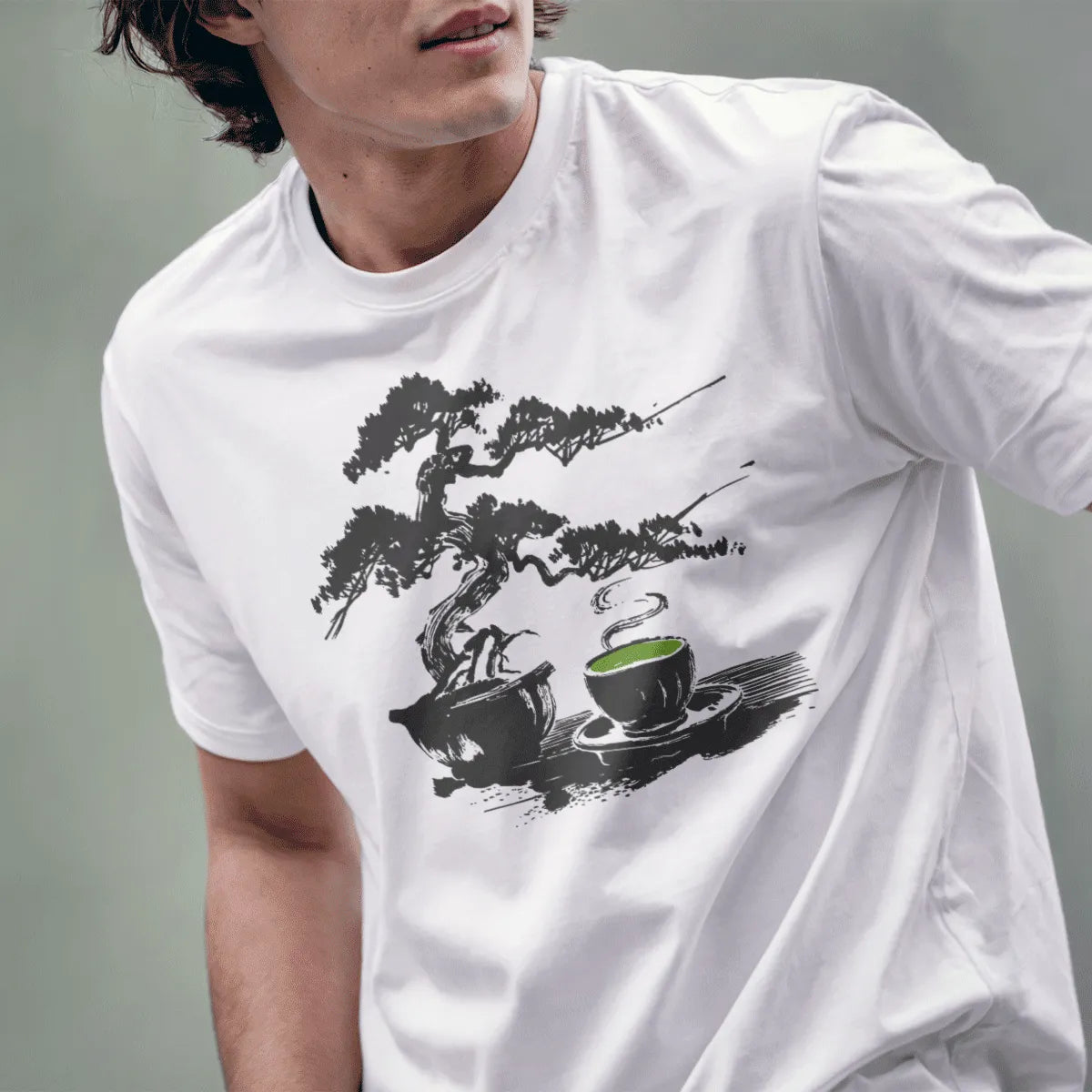 Male model in white t-shirt with bonsai and tea cup design, tranquil Japanese garden vibe.