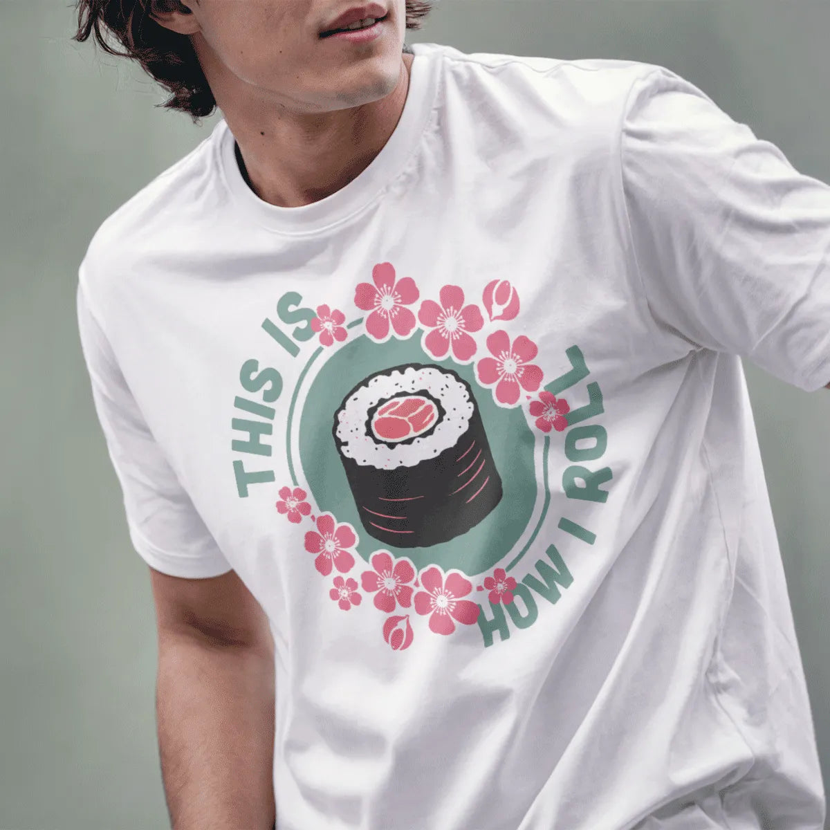 Male model in white t-shirt with sushi roll, cherry blossoms, and "THIS IS HOW I ROLL", sushi shirt, sushi pun.