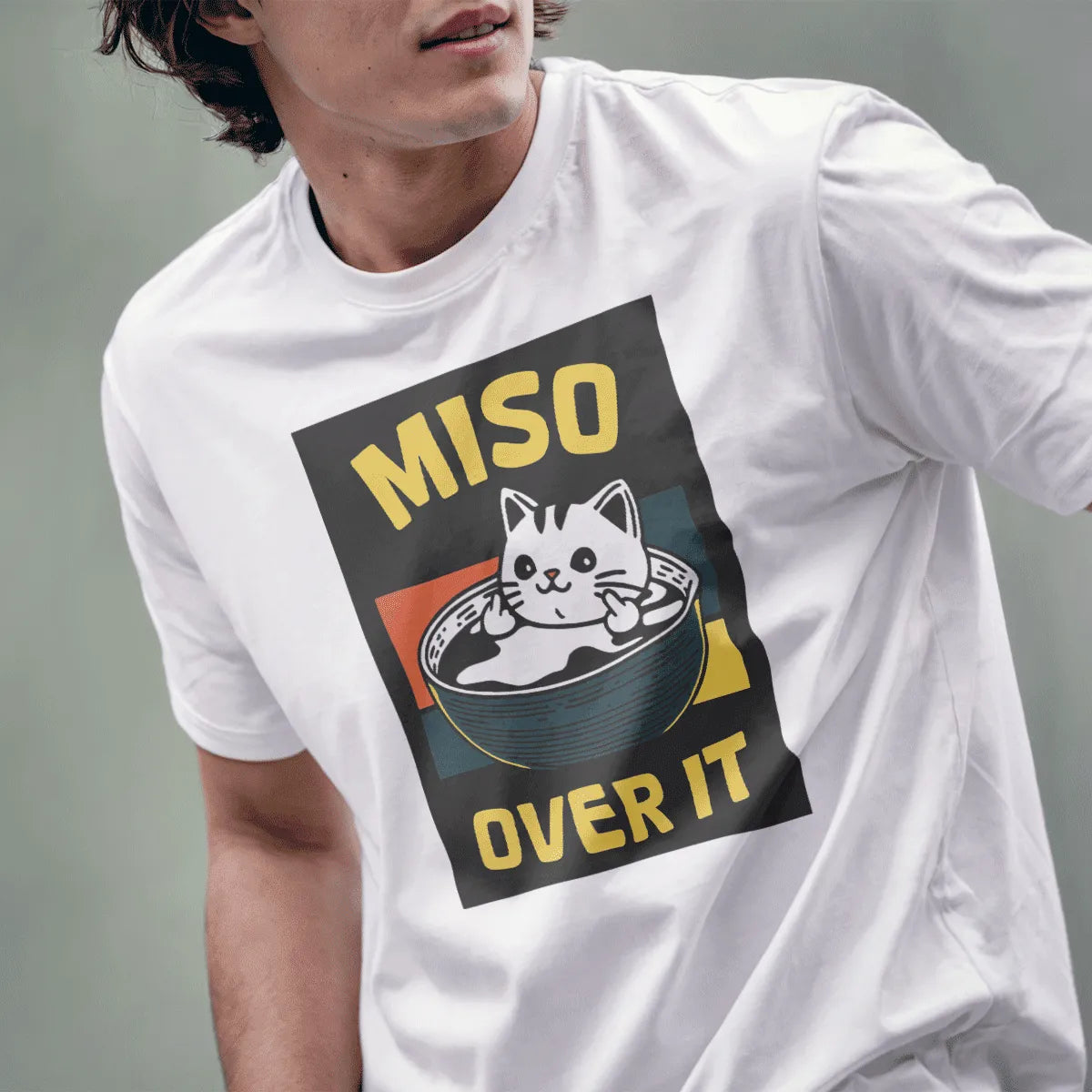 Male model in white t-shirt, cat in miso soup bowl, middle fingers, MISO OVER IT text, funny cat shirt.