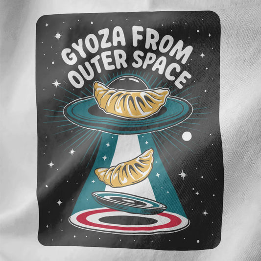Whimsical space-themed gyoza design on white fabric, bold phrase and cosmic illustration.