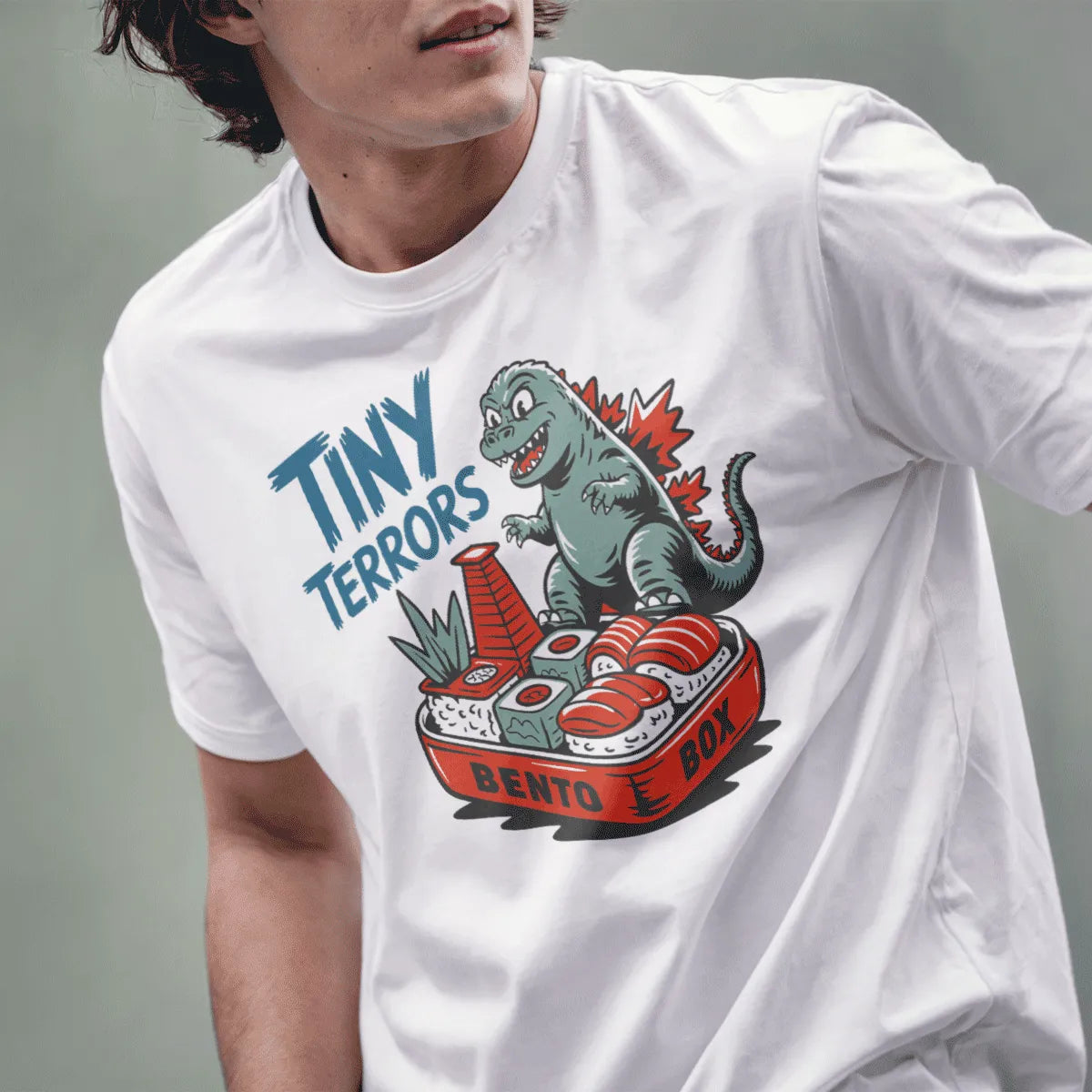 Male model in white t-shirt with quirky Godzilla bento box, Japanese t-shirts, anime t shirts.