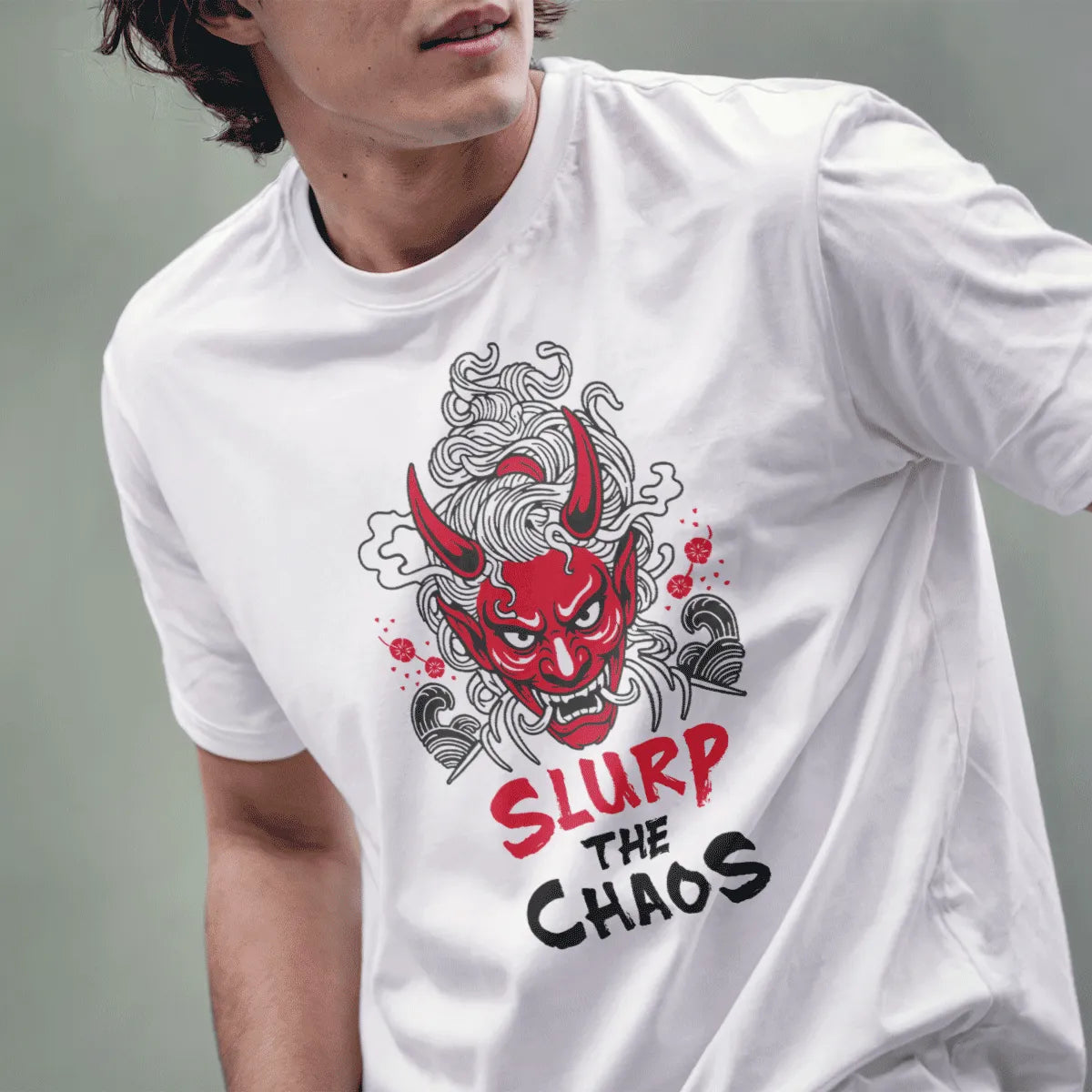 Male model in white t-shirt featuring red oni mask, ramen noodles, and bold "SLURP THE CHAOS" text, ramen t-shirt.