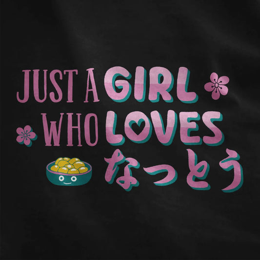 Black fabric close-up of cute natto graphic, teal and pink slogan, and cherry blossoms, japanese t shirts.