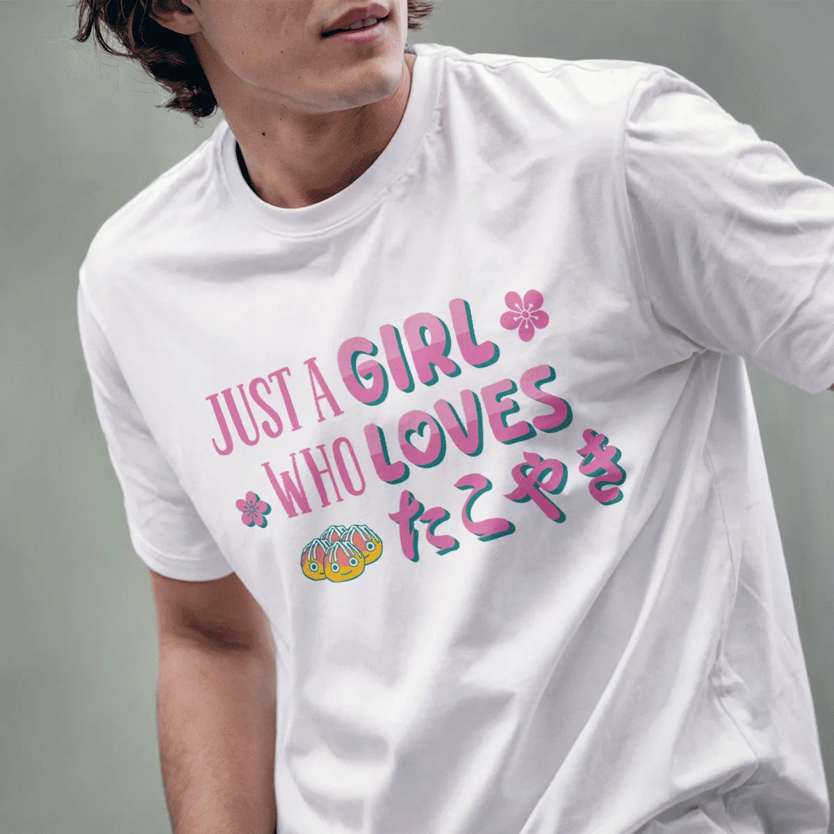 Male model in white t-shirt with cheerful takoyaki balls, pink blossoms, and lively slogan, japanese graphic tees.