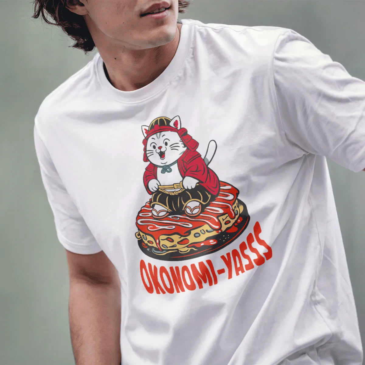 Male model wears white t-shirt with samurai cat, okonomiyaki, and humorous quote.