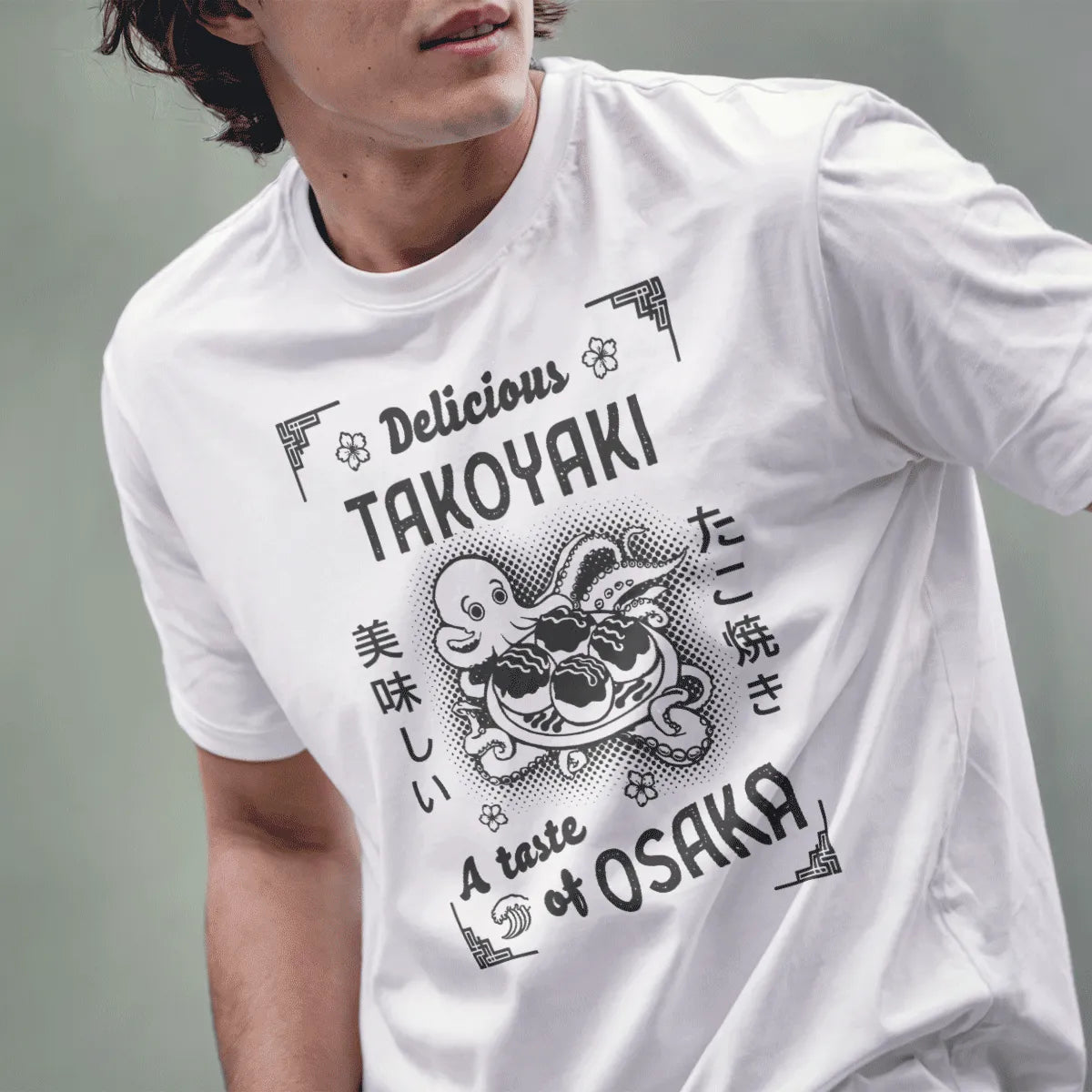 Male model in white t-shirt featuring cartoon octopus, “Delicious TAKOYAKI” text, and floral accents.