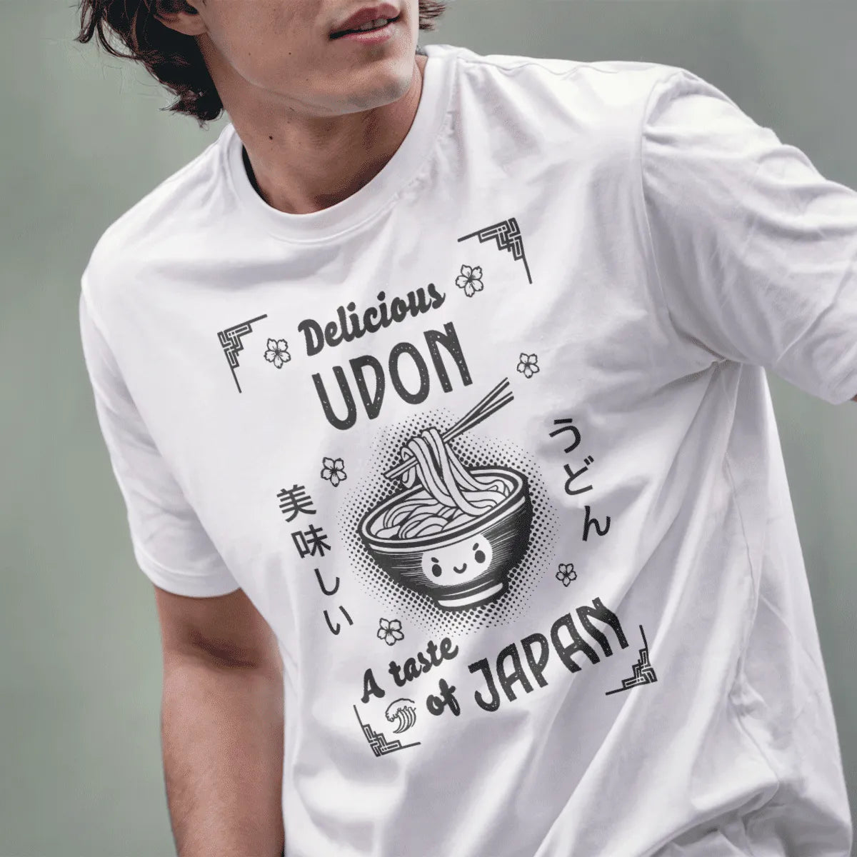 Male model in white t-shirt featuring cheerful udon bowl, bold "UDON" text, and floral accents, japan tee shirts.