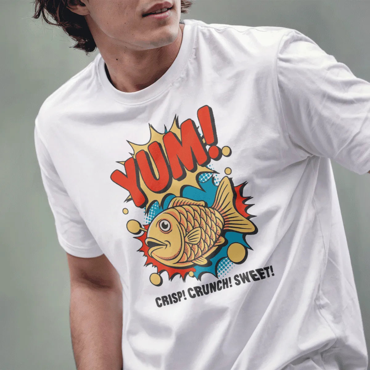 Male model in white t-shirt, cheerful taiyaki fish, "YUM!" text, japanese t-shirts, junk food shirt.