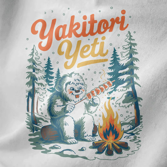 Yeti enjoying yakitori by a campfire on white shirt, snowy forest, playful winter feast, japanese t-shirts.