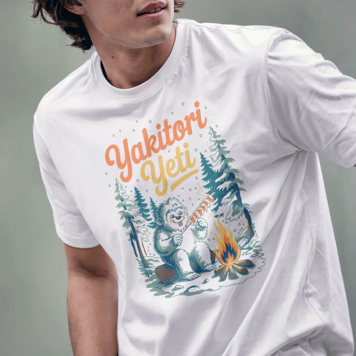 Male model in white t-shirt with Yakitori Yeti design, cheerful monster mashup, winter feast.