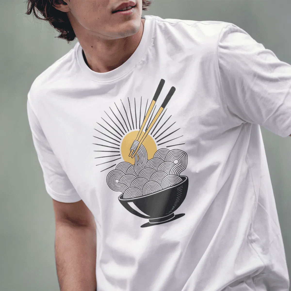 Male model in white noodle sunburst t-shirt, energetic ramen t-shirt design with chopsticks and sun rays.