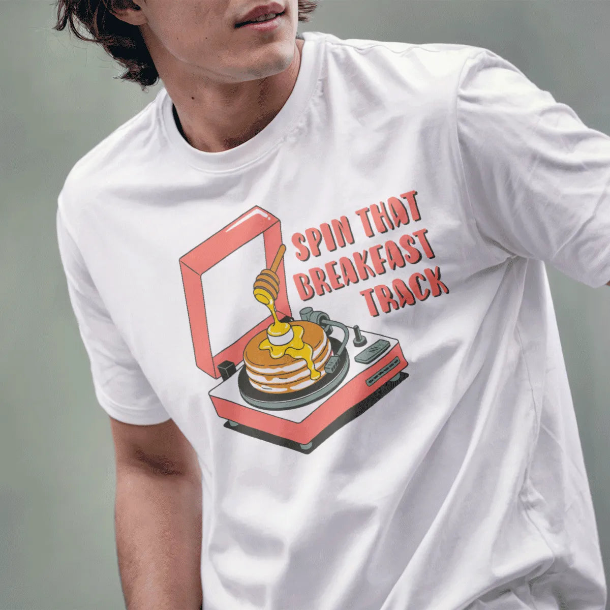 Male model in white t-shirt with cartoon record player, pancakes, and bold breakfast quote. japanese t-shirts