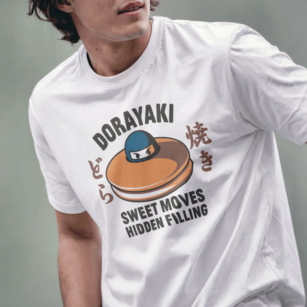 Male model in white t-shirt with dorayaki, ninja face, and "Sweet Moves Hidden Filling" humorous quote.