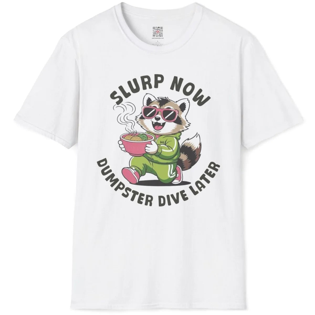 White t-shirt flatlay with raccoon eating ramen, pink sunglasses, cartoonish style, positive messaging.