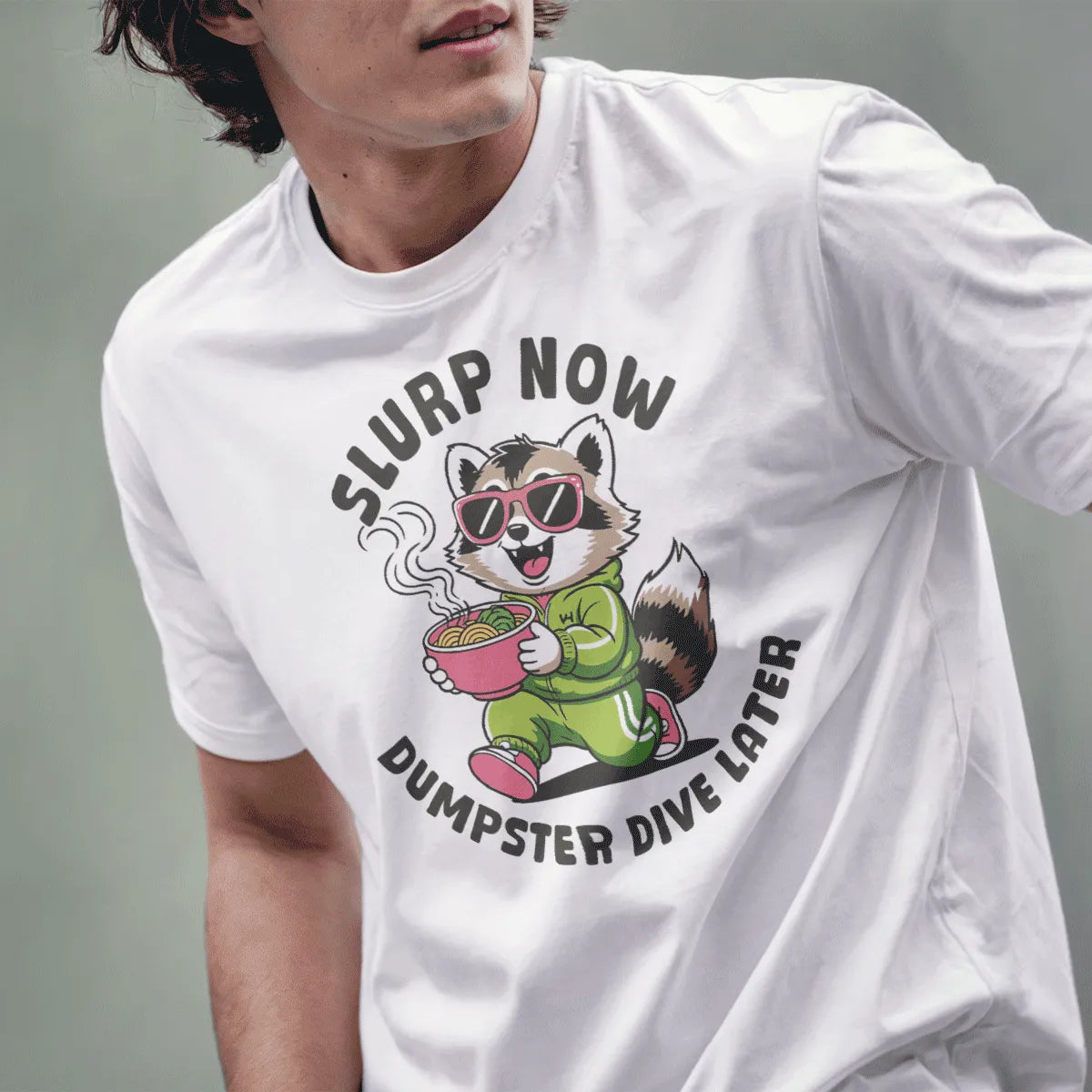 Male model in white t-shirt with raccoon eating ramen, oversized sunglasses, streetwear styles for men.
