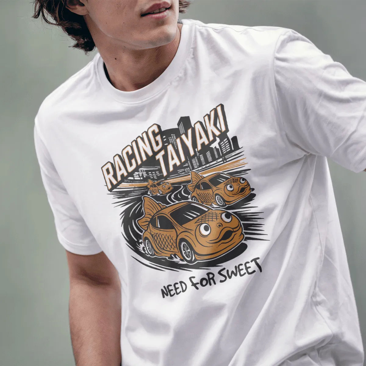 Male model in white Racing Taiyaki t-shirt with taiyaki cars, golden lettering, and cartoonish style.