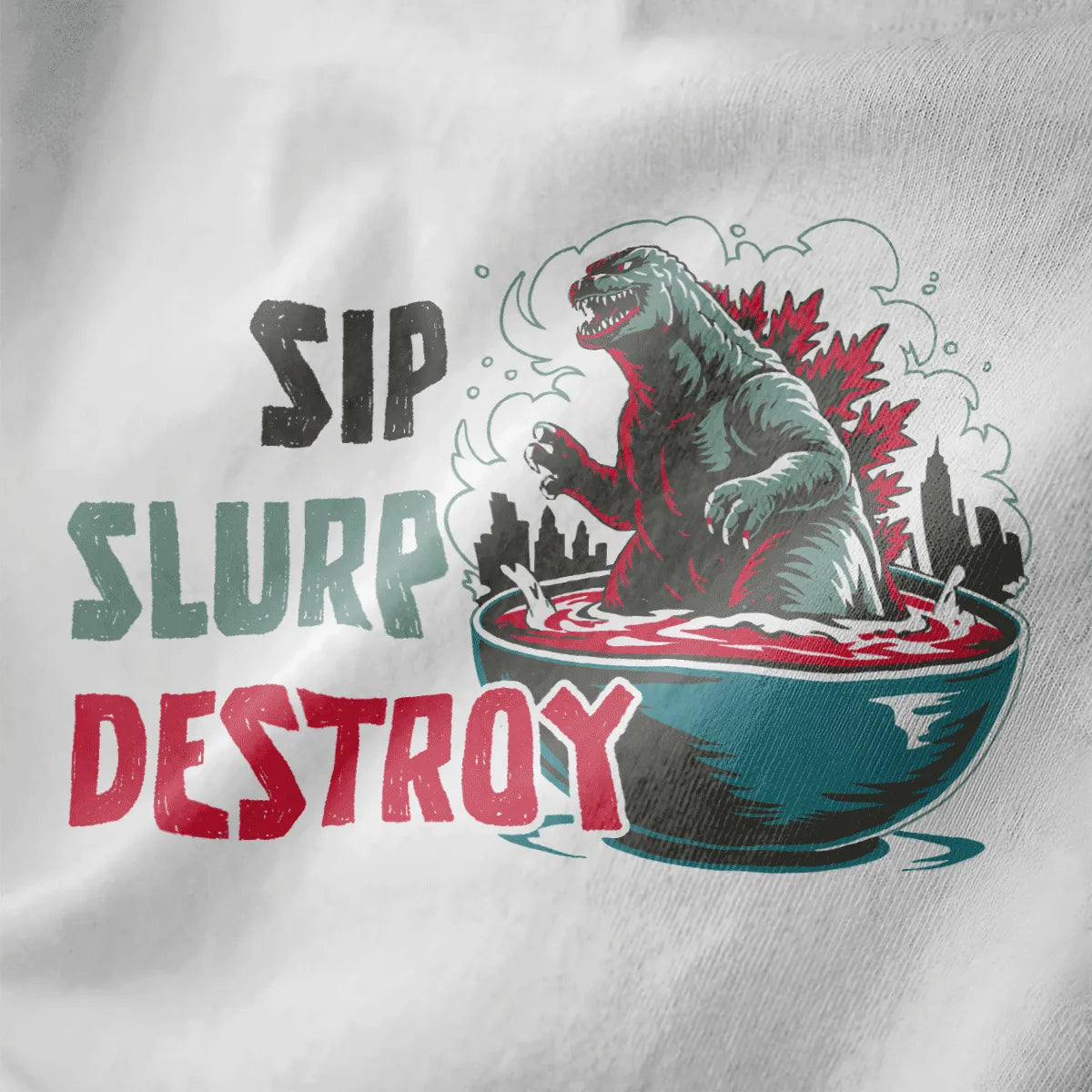 Godzilla-like monster rising from ramen bowl, city skyline, and "SIP SLURP DESTROY" on white fabric, ramen t-shirt.
