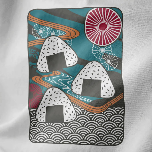 Playful onigiri trio with sesame and nori on teal, white fabric closeup, japanese t-shirts, ukiyo-e designs.