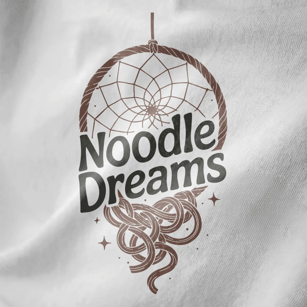 Close-up of white fabric featuring circular dreamcatcher with flowing ramen noodles and sparkling stars.