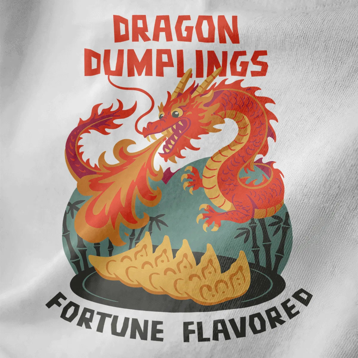 Close-up of white t-shirt fabric with fiery dragon, golden gyoza dumplings, and bold vintage lettering.