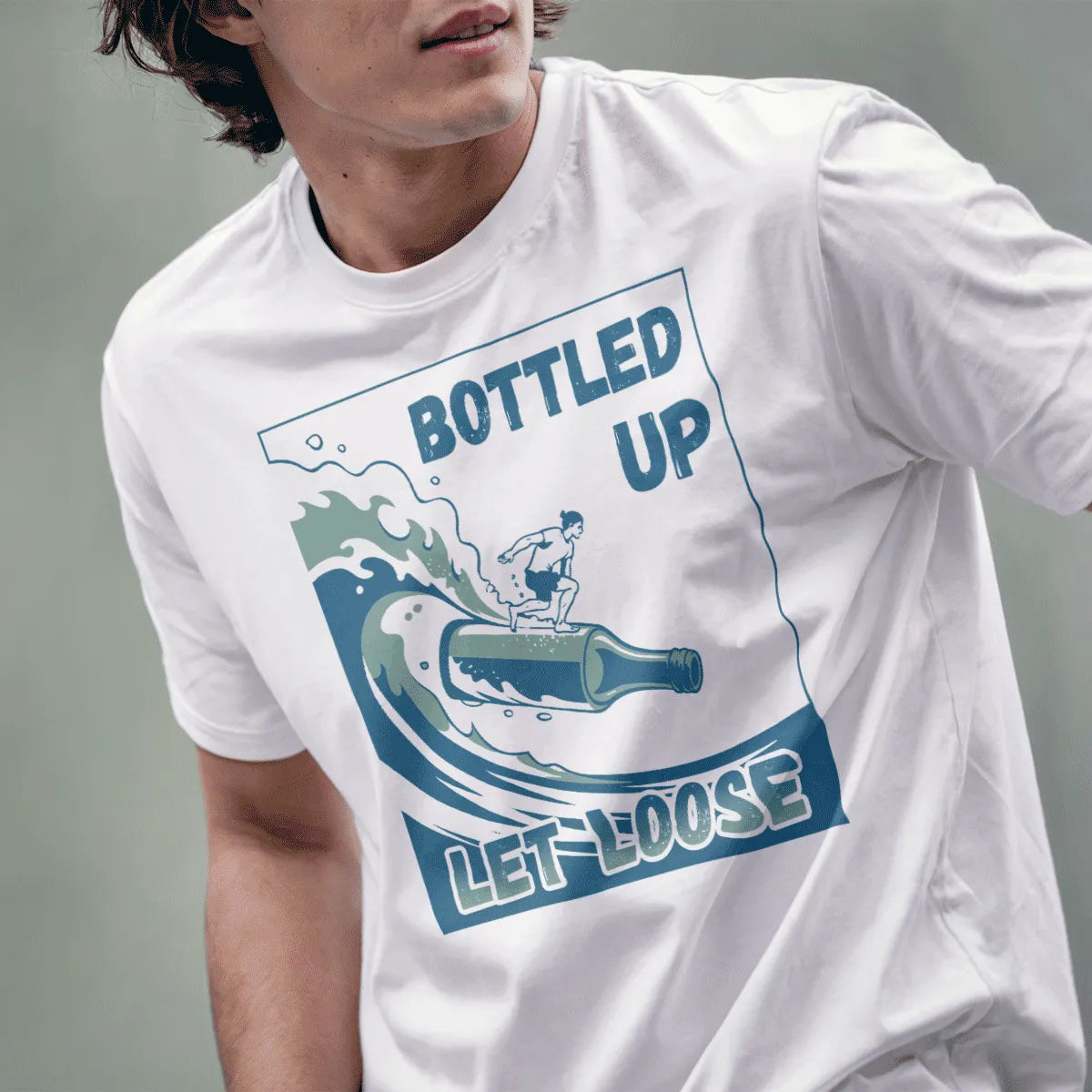 Male model wearing white t-shirt with playful bottle surfboard, athletic surfer, and "Let Loose" beach font.