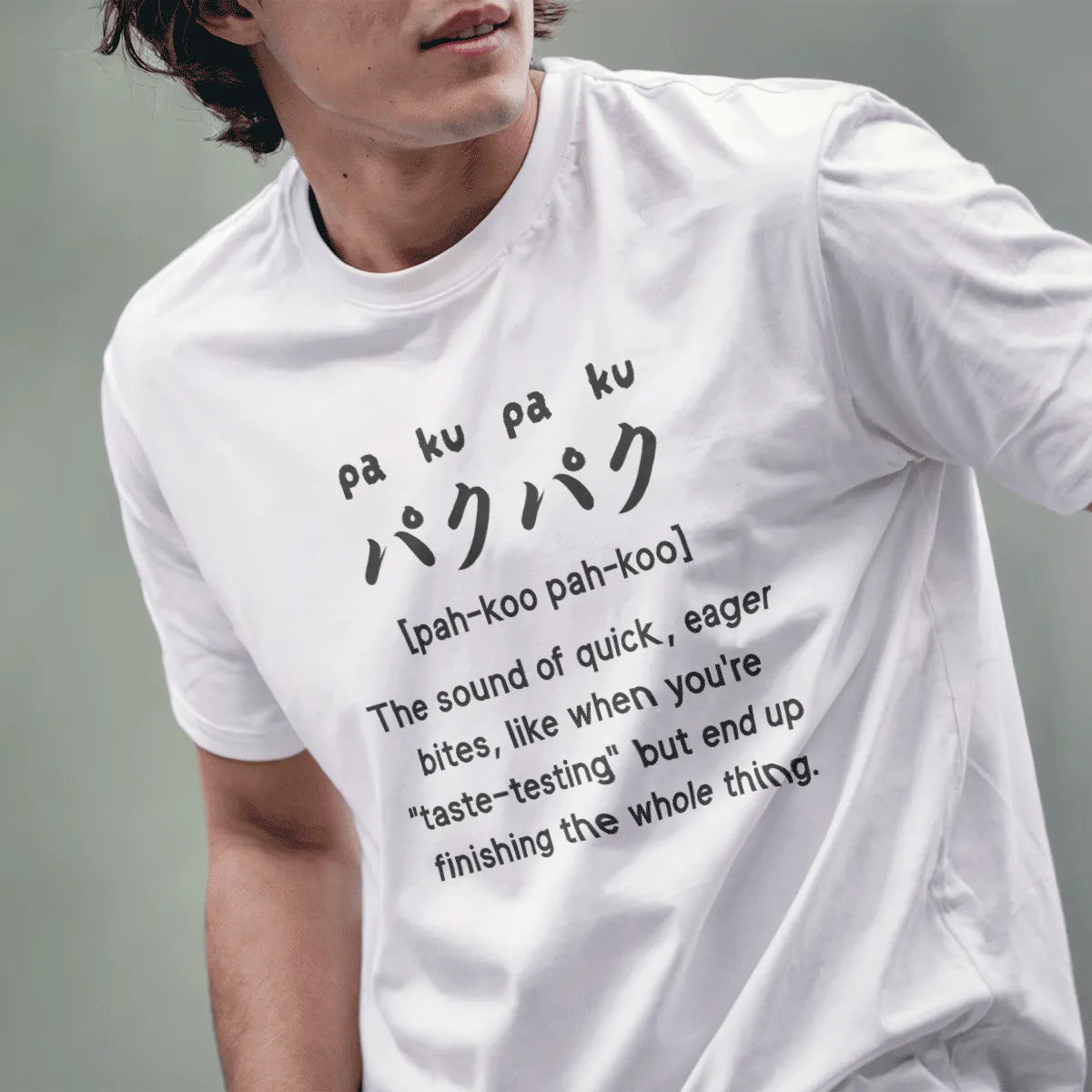 Male model in white t-shirt with "paku-paku" Japanese and English text, cool design for shirts, unisex t-shirt.