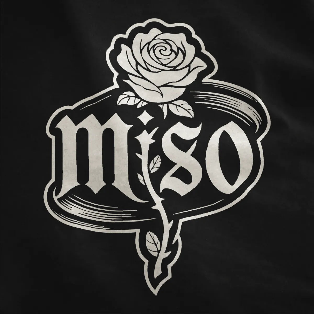 Black shirt close-up shows detailed black and white rose with leaves and thorns, gothic miso font inside sketch oval.