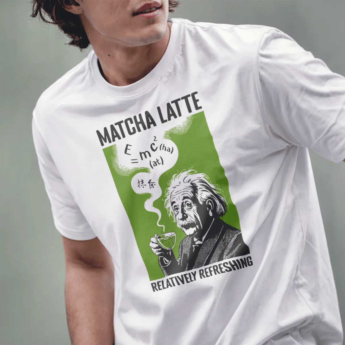 Male model in white shirt with retro Einstein holding green matcha latte, chunky MATCHA LATTE text above.