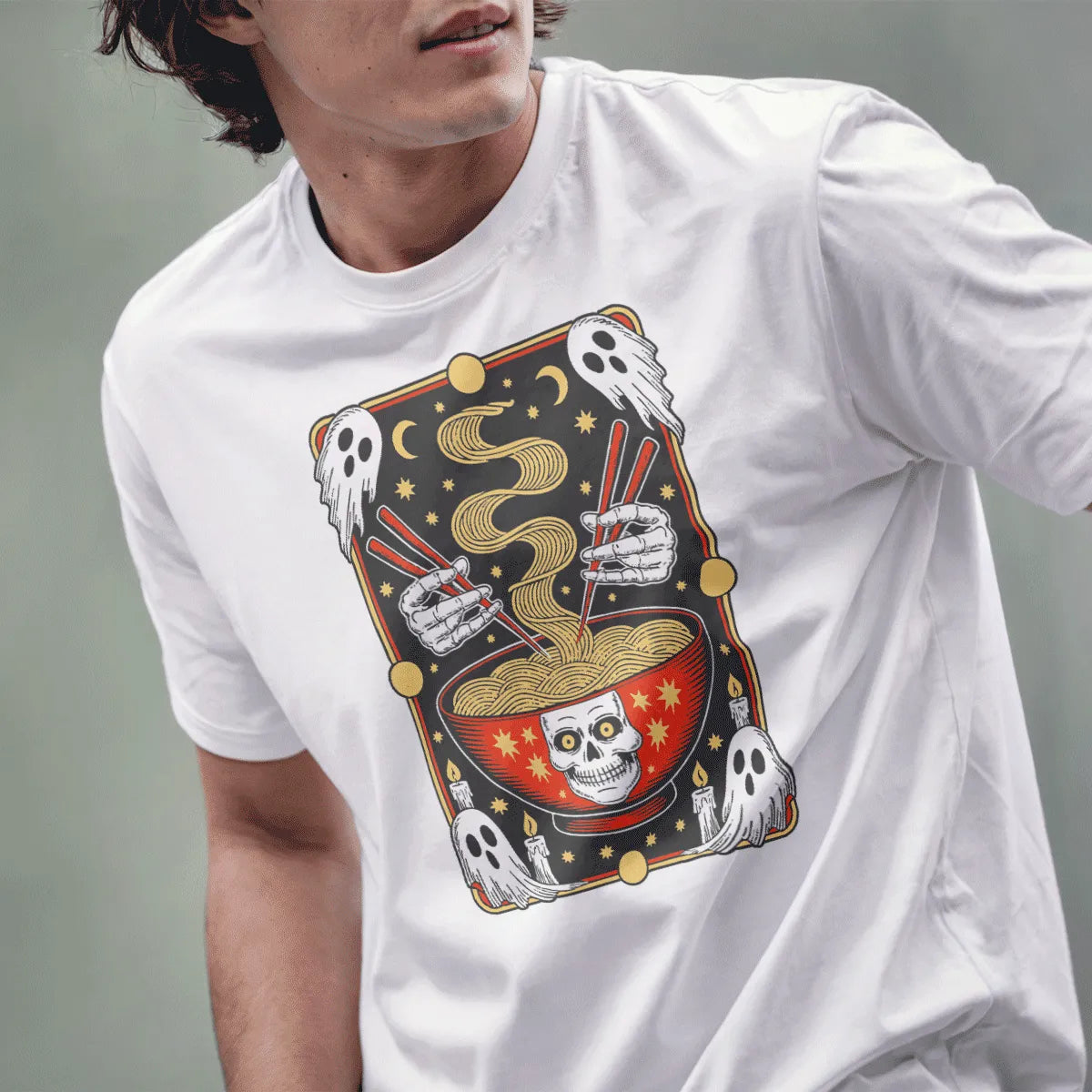 Male model in white shirt with ramen bowl, skull motif, and floating ghosts, bold whimsical gothic design.