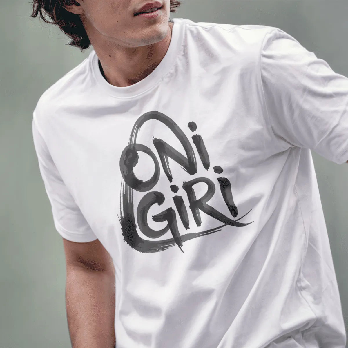 Male model wearing white tee with large, brushstroke "Onigiri" text in monochrome palette.