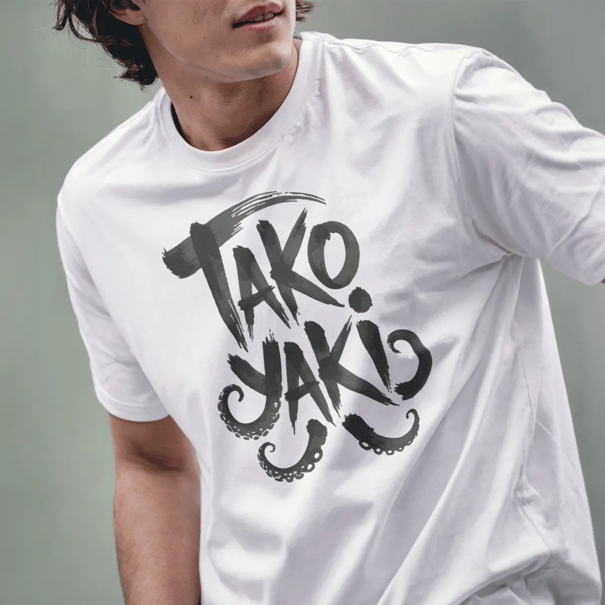 Male model wearing white tee featuring energetic "TAKO YAKI" hand-drawn text with octopus tentacles.