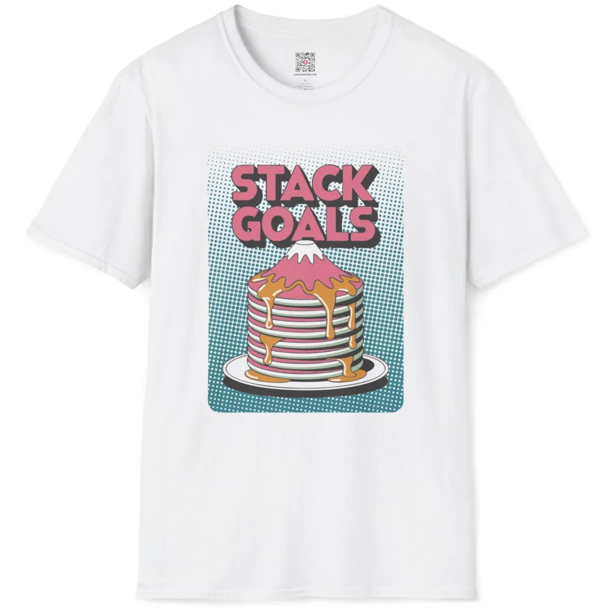 White flatlay tee with vibrant pastel pancake mountain and playful pink block "STACK GOALS" text on teal dots.