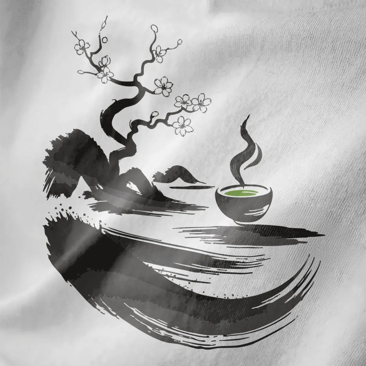Close-up of white fabric with sumi-e twisted tree, white cherry blossoms, and green matcha bowl.