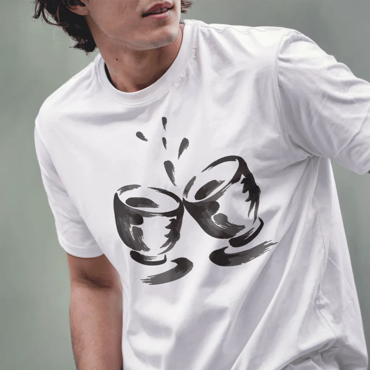 Male model wearing white t-shirt with artistic black and grey brushstroke sake cups design.