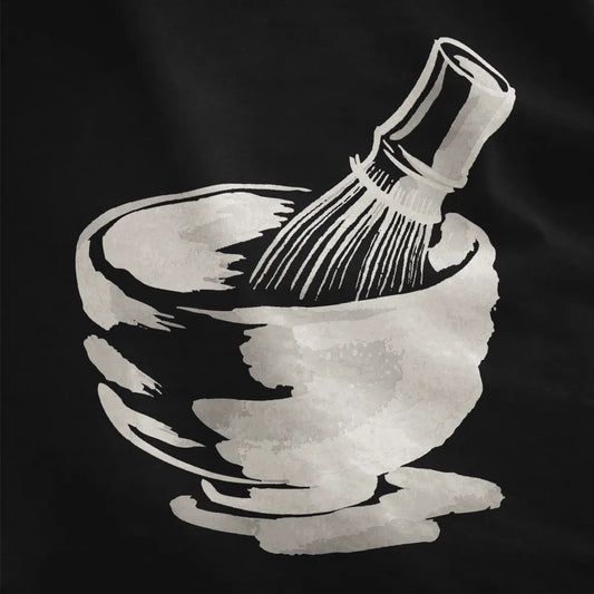 Black fabric close-up with artistic matcha preparation brushstroke, peaceful imagery and cultural symbolism.