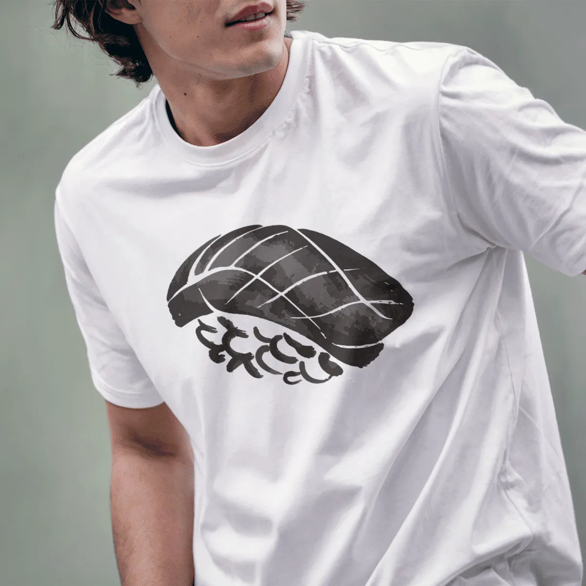 Male model wears white tee showcasing bold nigiri sushi graphic with artistic brushstroke style.