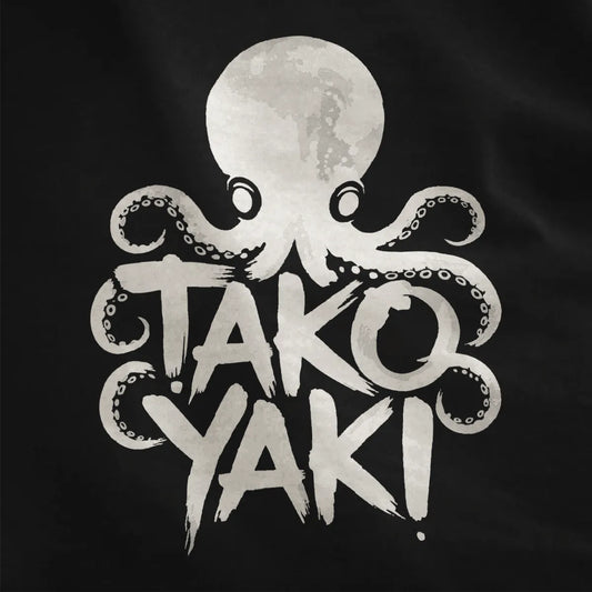 Dark fabric close-up with textured octopus and bold takoyaki brushstroke lettering, streetwear style.
