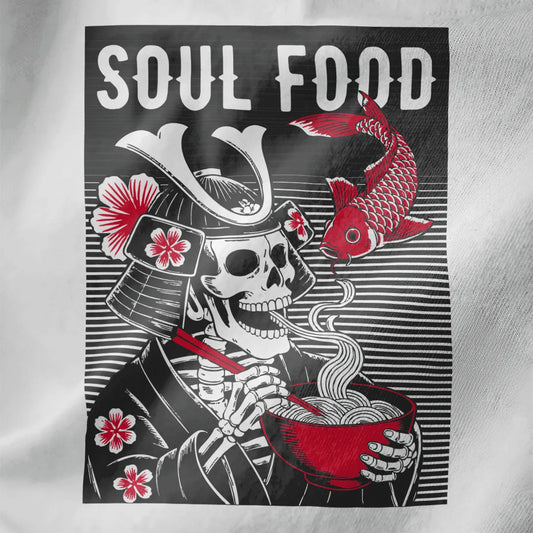 Close-up white fabric showing samurai skeleton with ramen bowl, koi fish, and cherry blossoms.