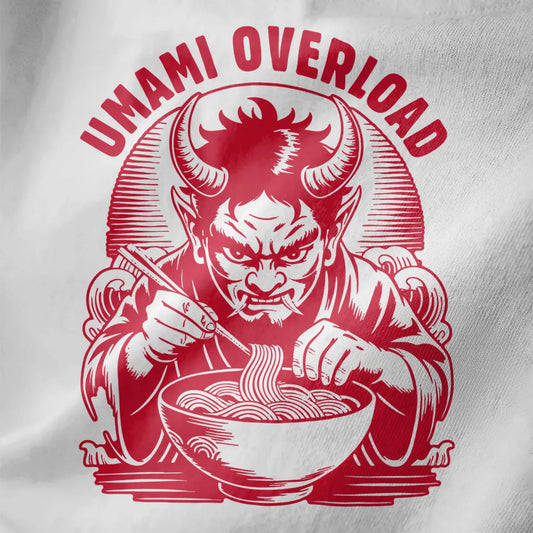 Close-up of white fabric tee with red oni demon eating ramen using chopsticks, bold artistic design.
