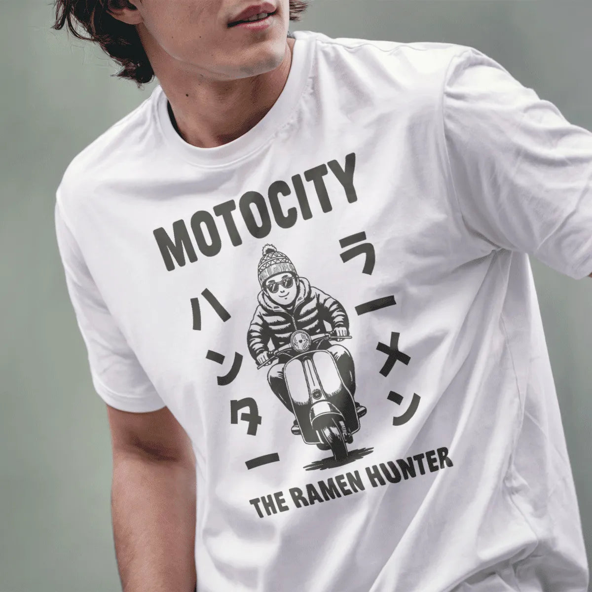 Male model wearing white tee featuring monochrome scooter rider with shades and Japanese text "THE RAMEN HUNTER."