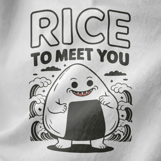 Close-up of white fabric tee with playful cartoon onigiri and pun "RICE TO MEET YOU," waves and stars design.