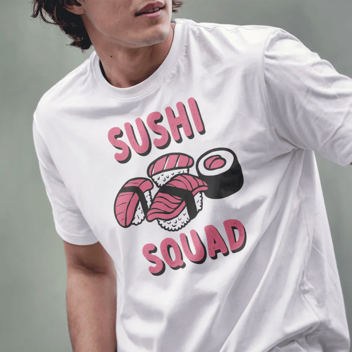 Male model wears white t-shirt with playful sushi pieces and bold pink "SUSHI SQUAD" text. sushi shirt, sushi squad